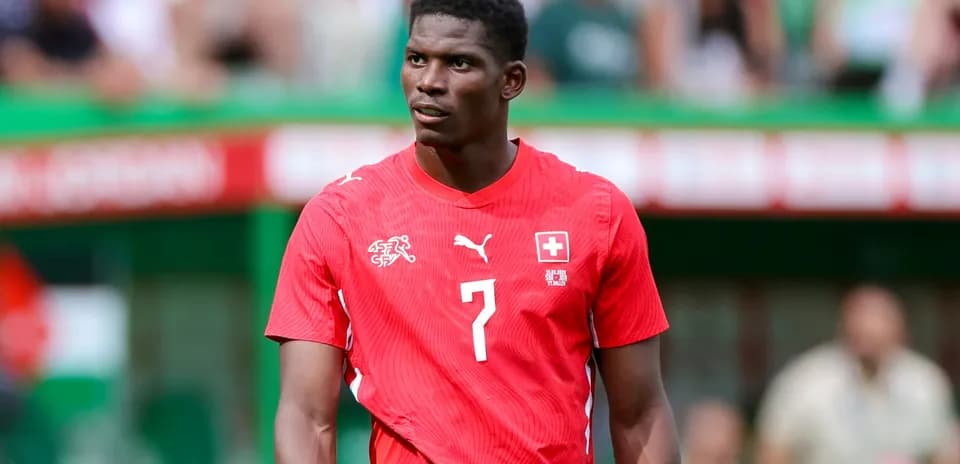 Player wearing red jersey during match on field