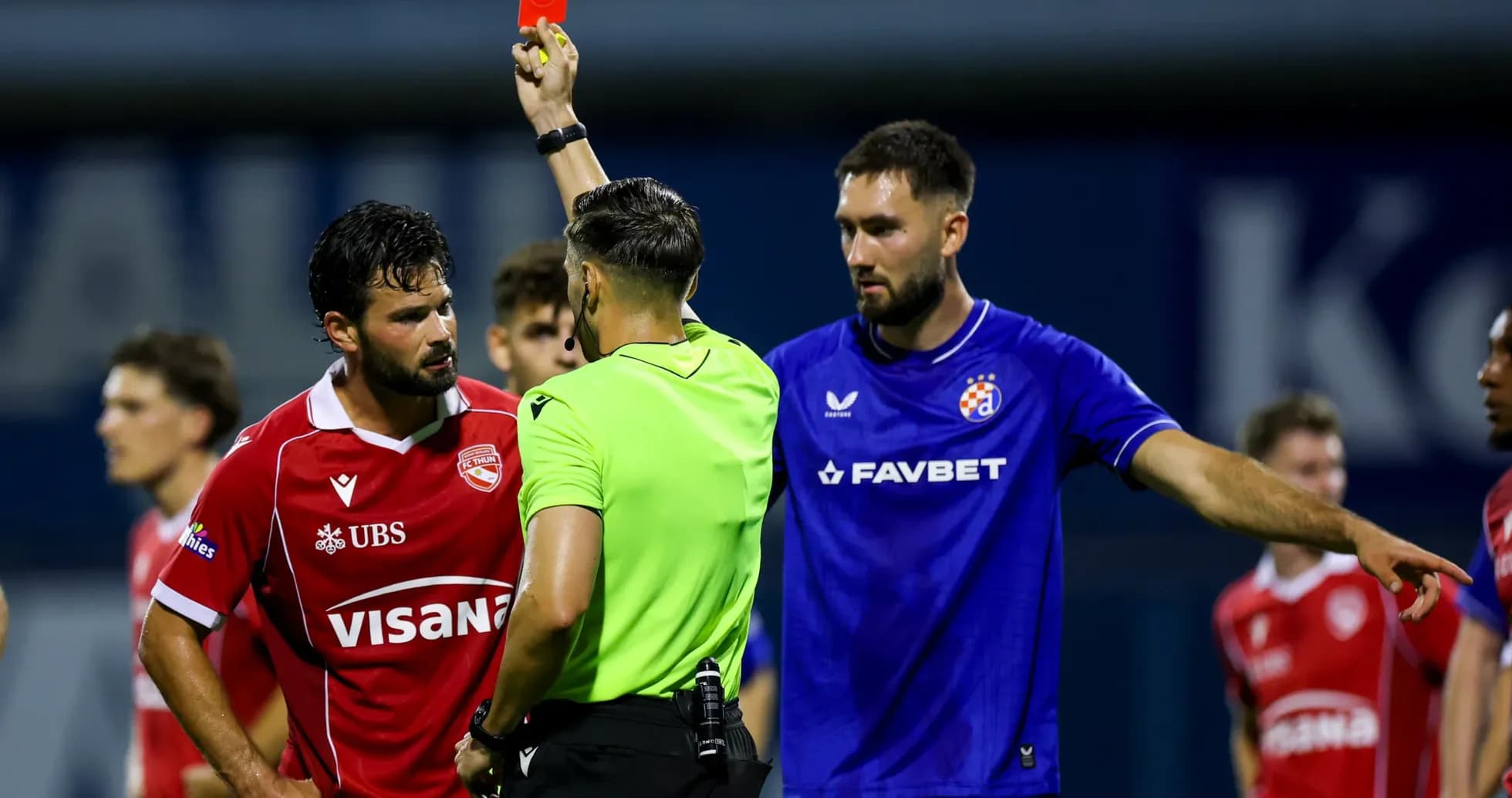 Referee showing red card during match