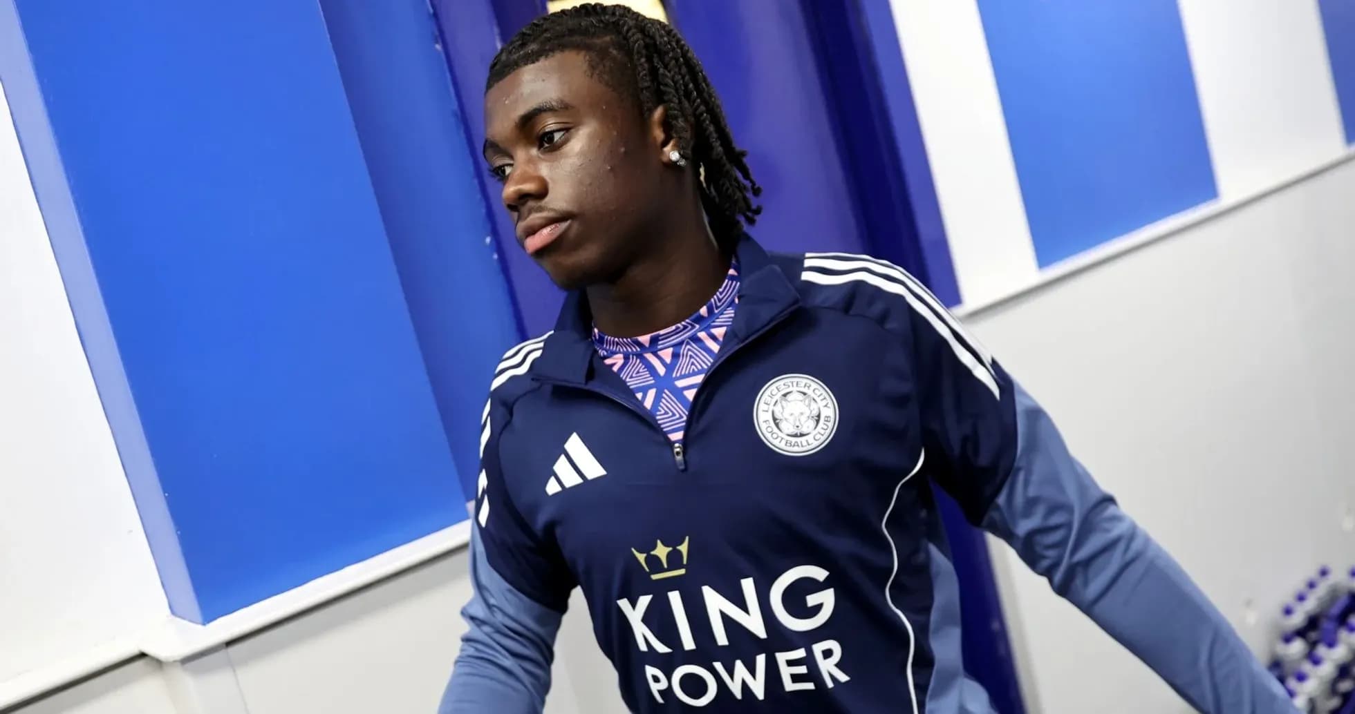 Player in Leicester City training gear entering room