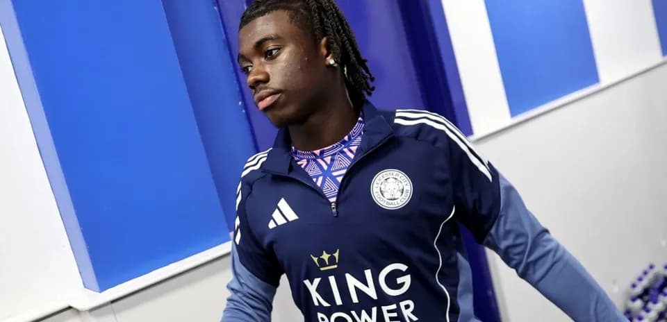 Player in Leicester City training gear entering room