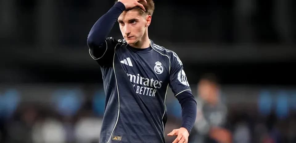Player in Real Madrid kit walking with hand on head