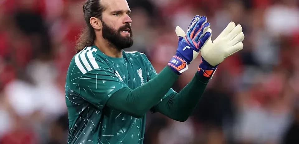Goalkeeper in green kit signaling during match
