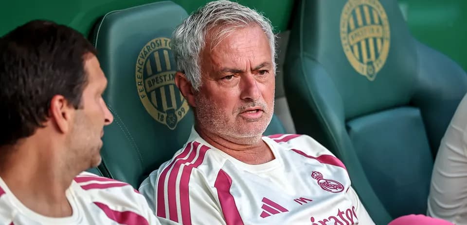 Manager discussing strategy on the bench during match