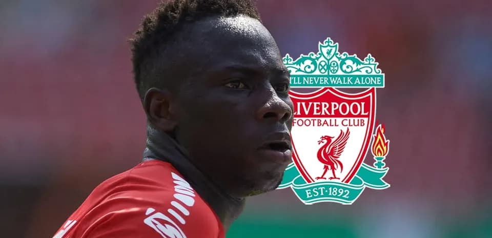 Player in Liverpool jersey with club logo background