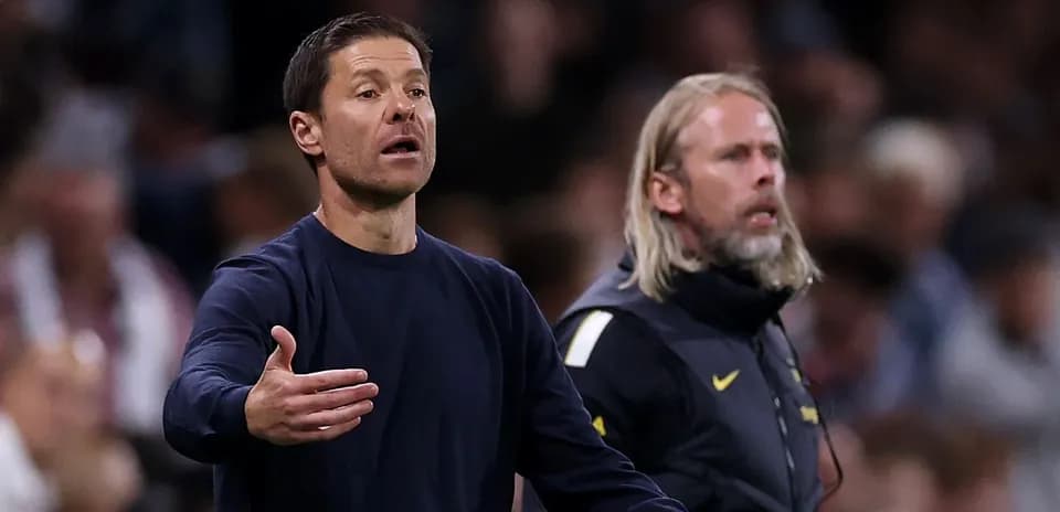 Coaches gesturing on the sidelines during match
