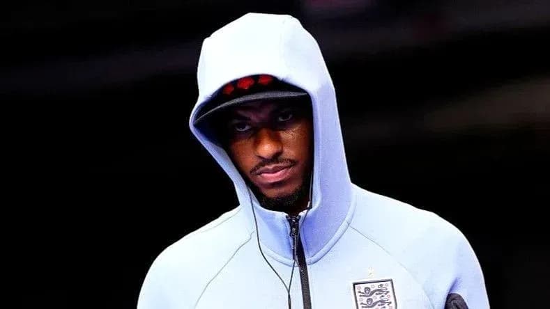 Player wearing a hooded jacket before match