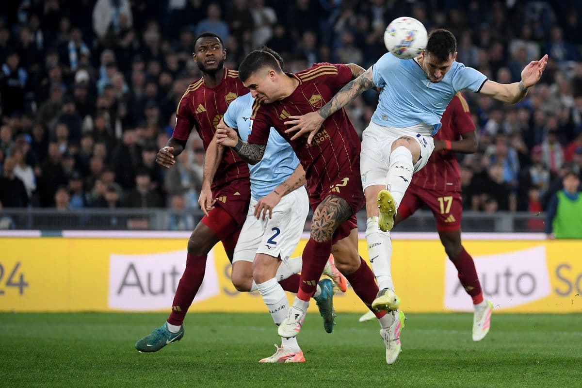 AS Roma players challenging Lazio opponent for the ball