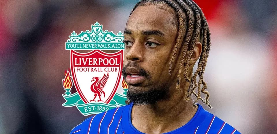 Player in blue kit with Liverpool logo background