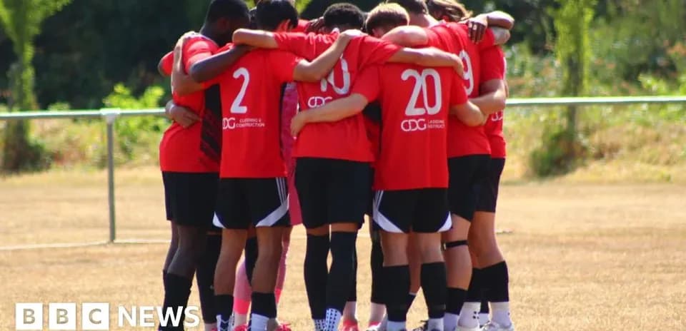 Team huddled together during practice on field