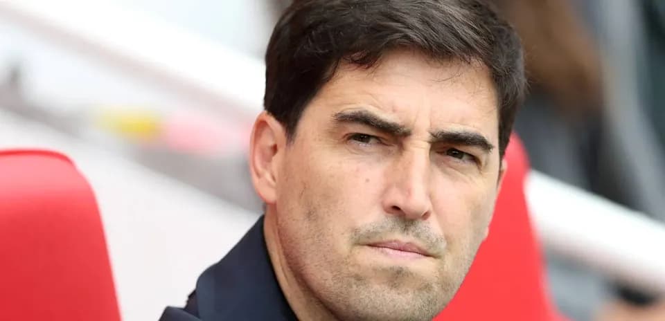 Coach observing from the sidelines during match