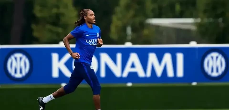 Player jogging on training pitch with team branding
