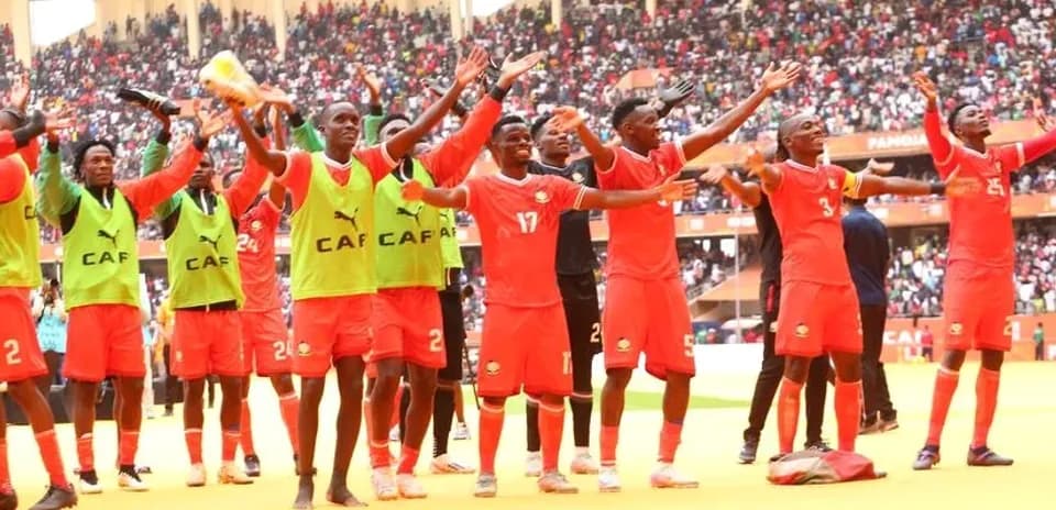 Players celebrating with fans in stadium after match