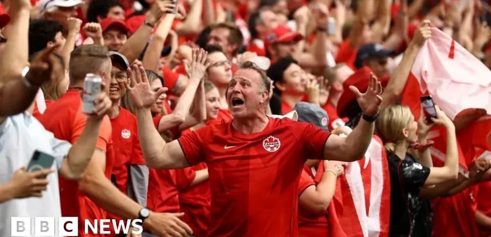 Fans celebrating in red attire at a sports event