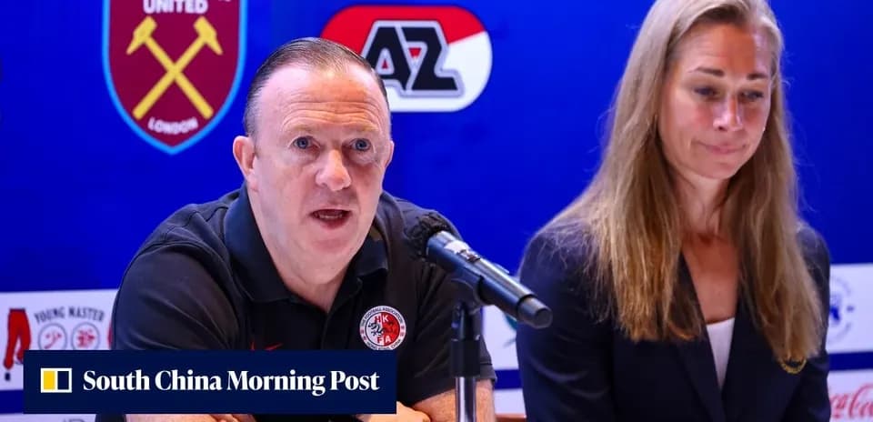 Manager speaking at press conference with colleague