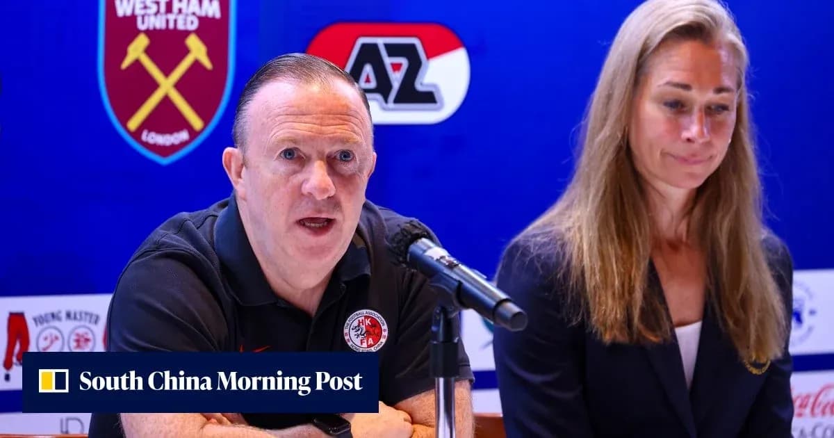 Manager speaking at press conference with colleague