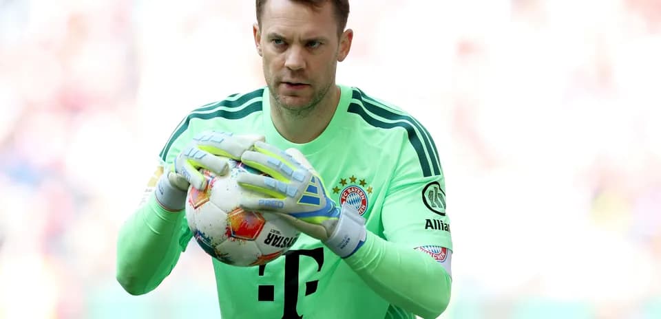 Goalkeeper holding ball before match at stadium