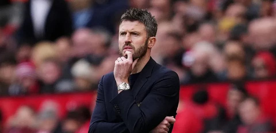 Coach observing the match with thoughtful expression