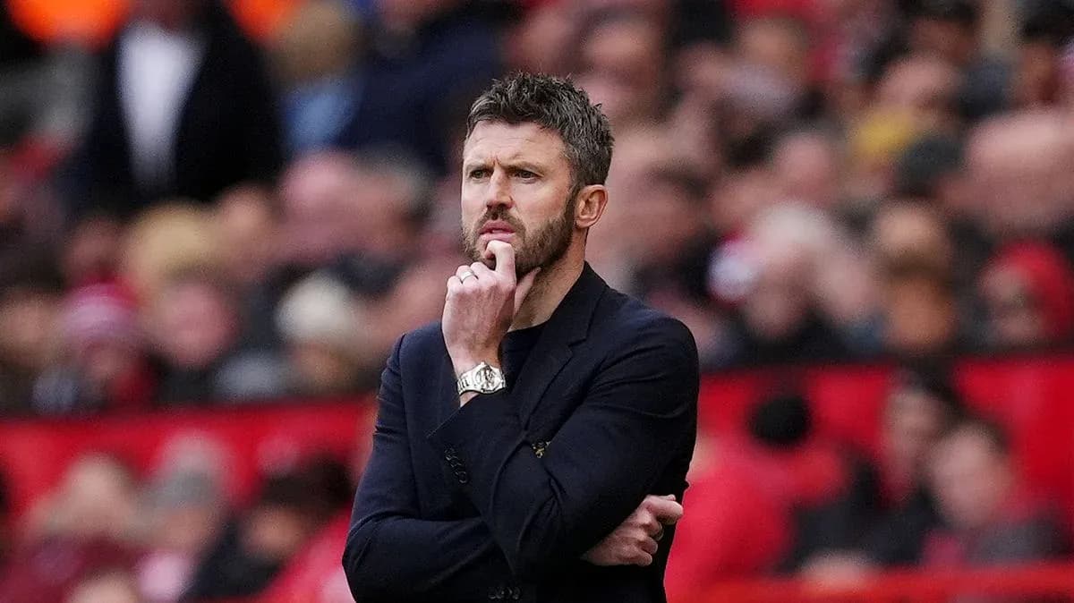 Coach observing the match with thoughtful expression