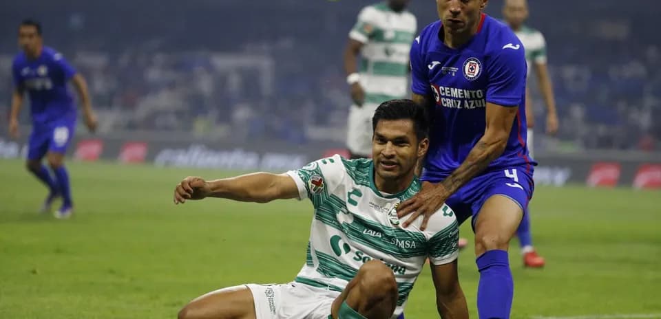 Players contesting for the ball during Liga MX match