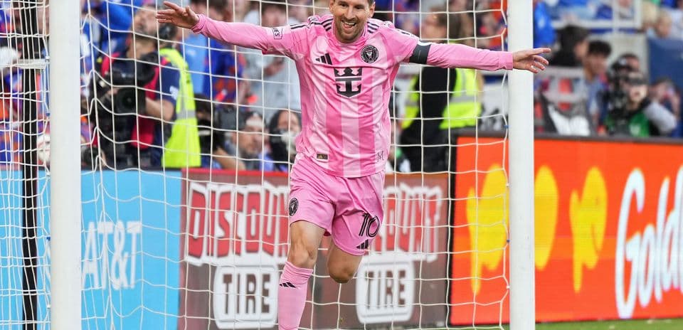 Player celebrating a goal in pink jersey