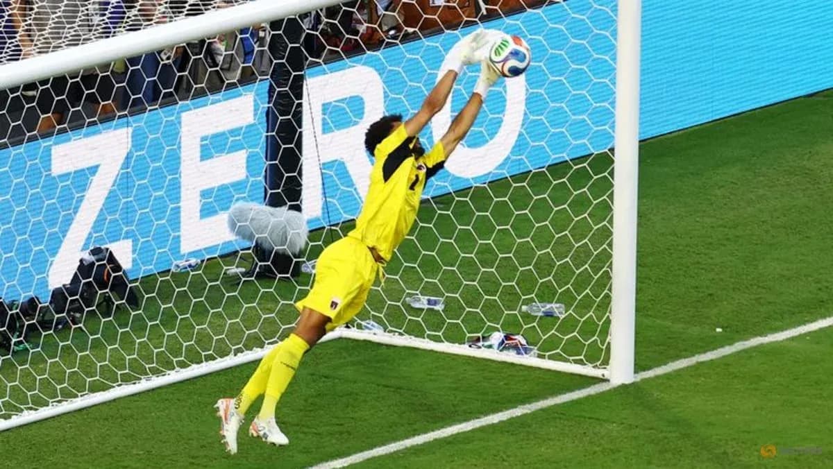 Goalkeeper diving to save a shot on goal