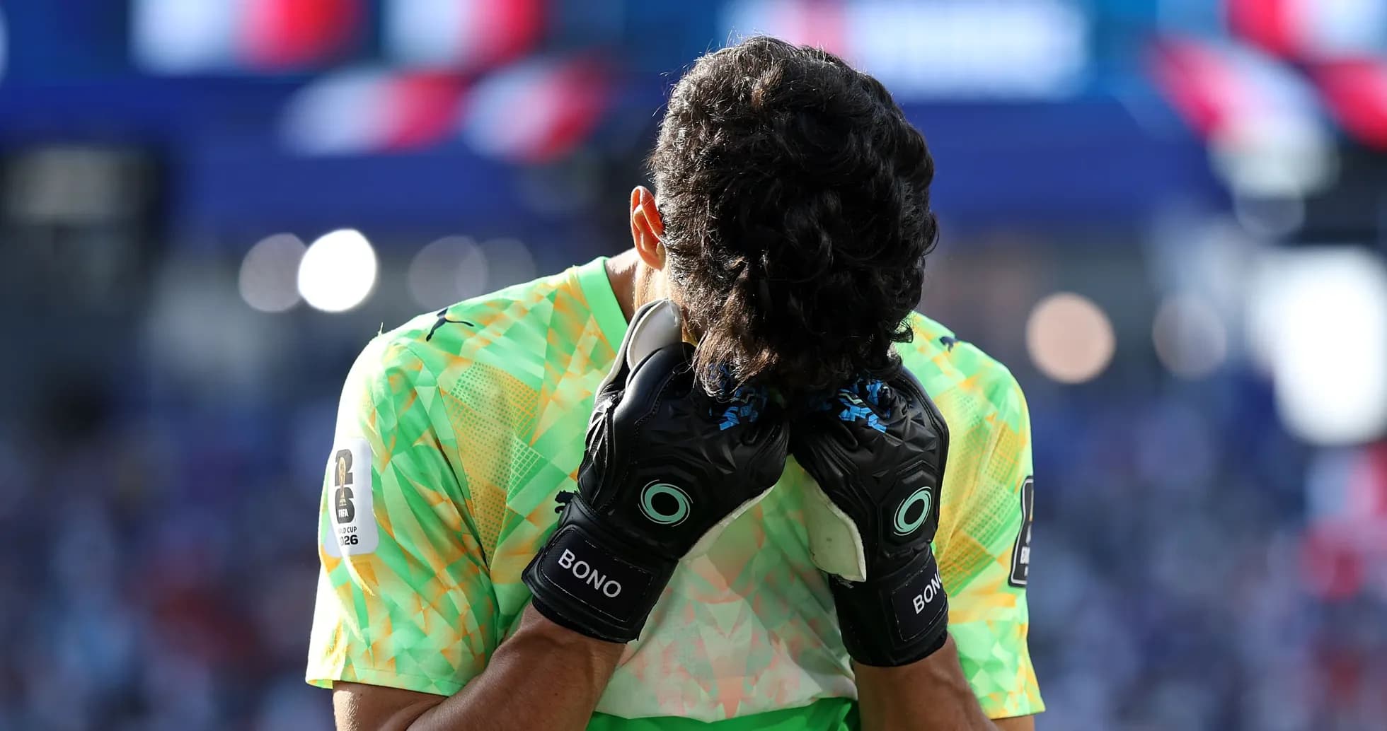 Goalkeeper holding head in hands during match