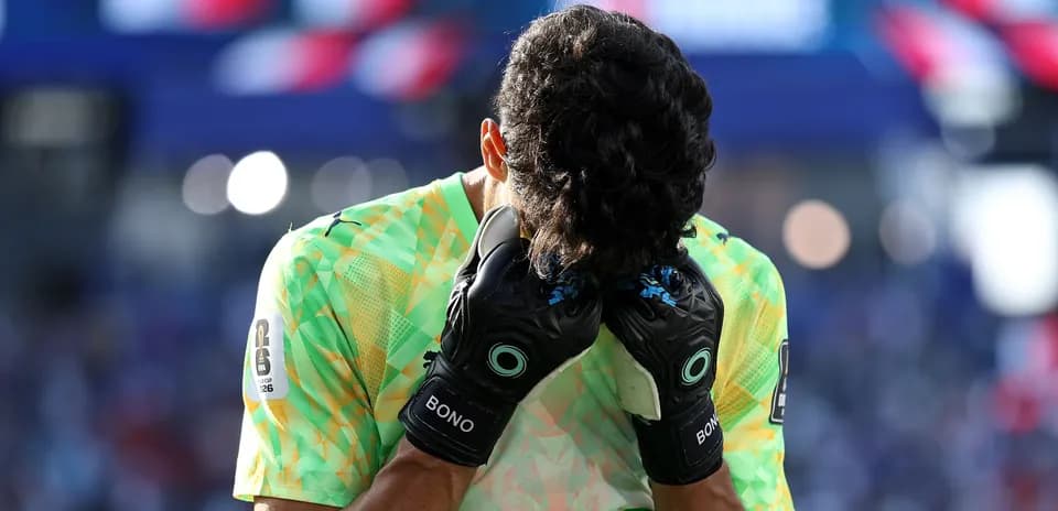 Goalkeeper holding head in hands during match