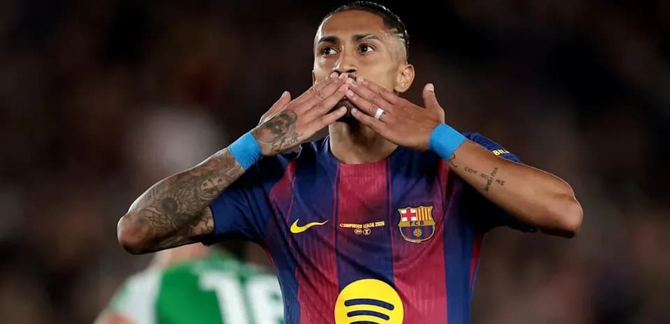Player celebrating with hand gestures on pitch