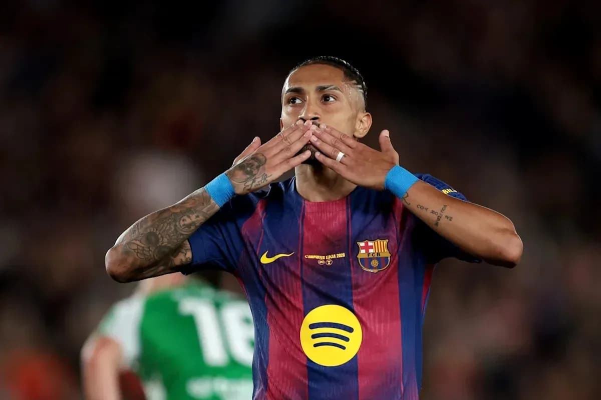 Player celebrating with hand gestures on pitch