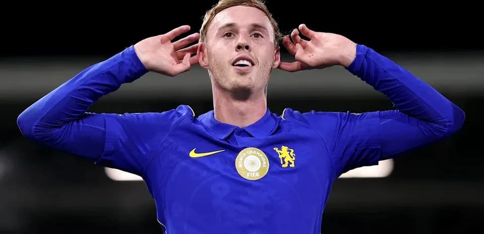Player celebrating with hands behind ears in blue jersey