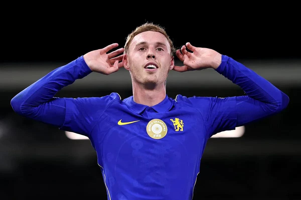 Player celebrating with hands behind ears in blue jersey