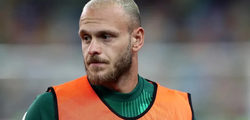 Goalkeeper wearing training bib on the sidelines