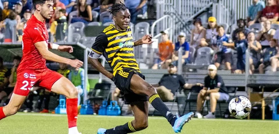 Player kicking ball during Pittsburgh Riverhounds match