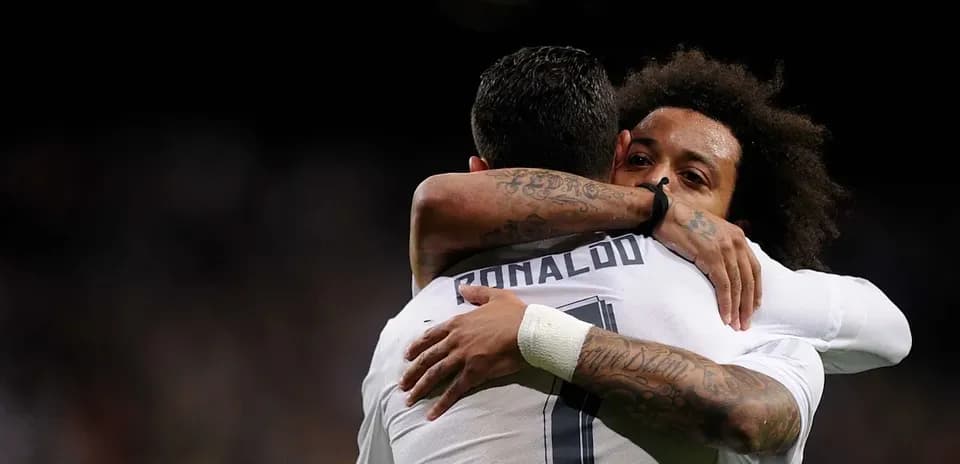 Cristiano Ronaldo and Marcelo hugging on the field