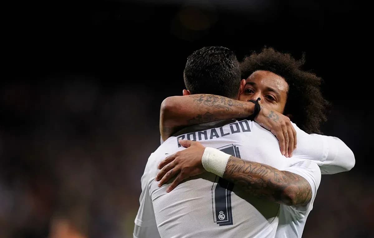 Cristiano Ronaldo and Marcelo hugging on the field