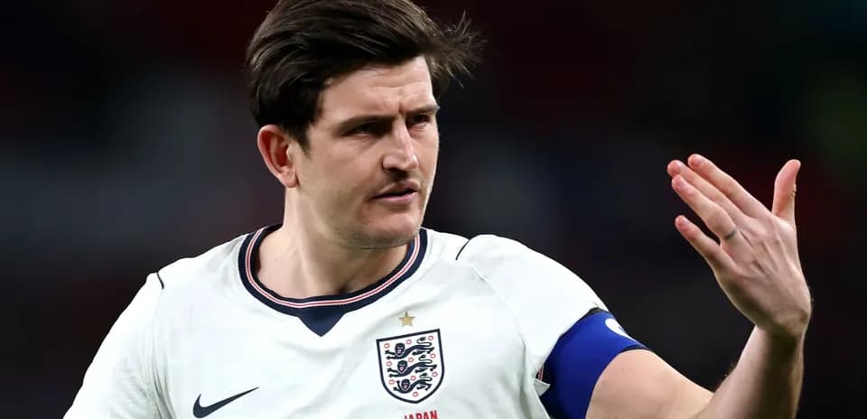 Player gesturing during England match in white kit