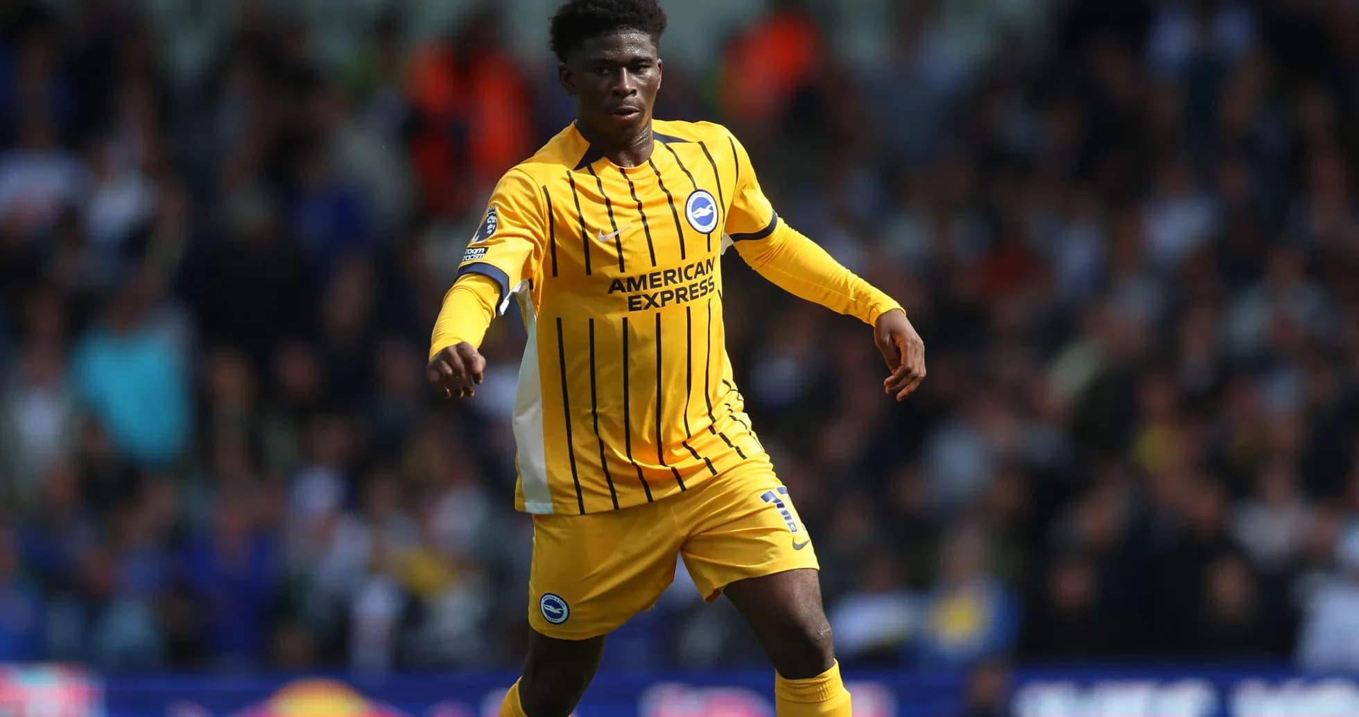 Player in yellow jersey running on the pitch