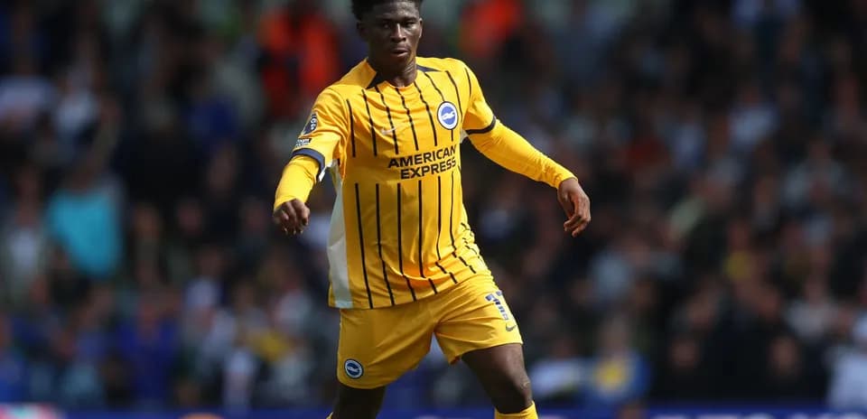 Player in yellow jersey running on the pitch