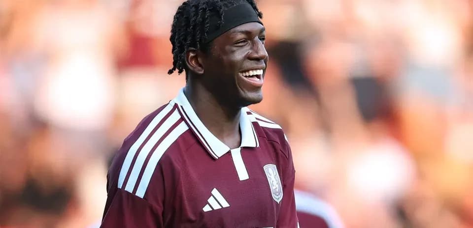 Player smiling during warm-up in maroon jersey