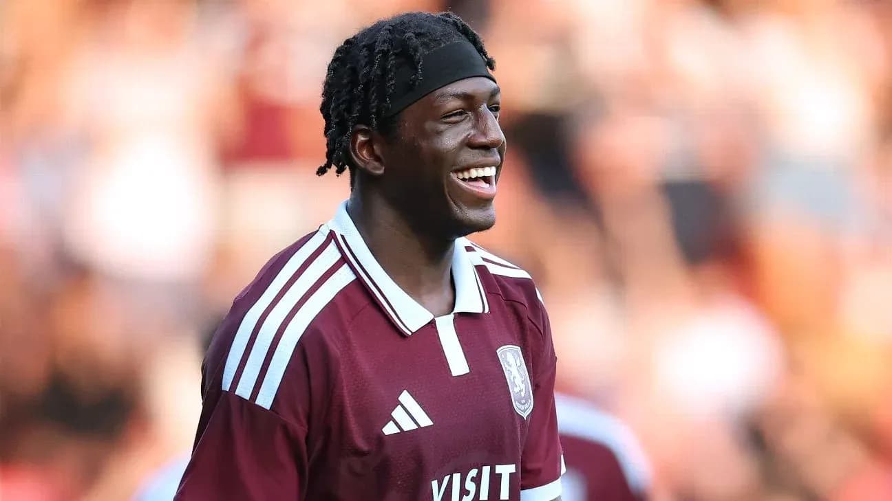 Player smiling during warm-up in maroon jersey