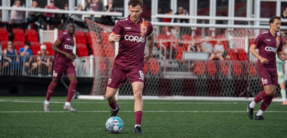 Player dribbling ball during USL Championship match