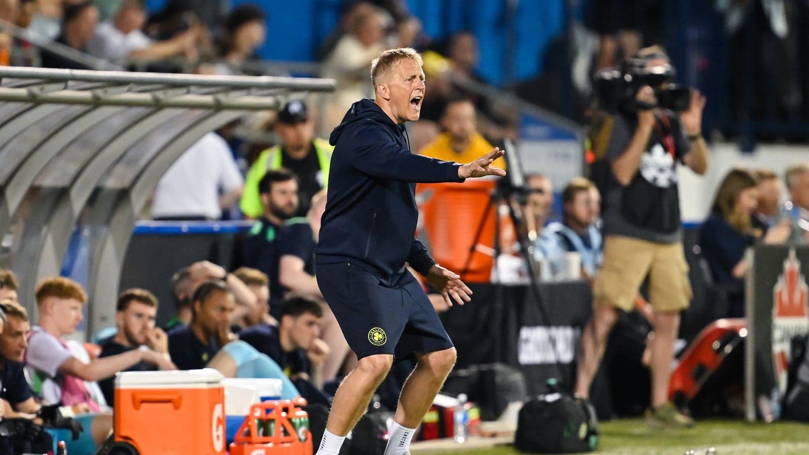 Coach directing players from the sidelines during match