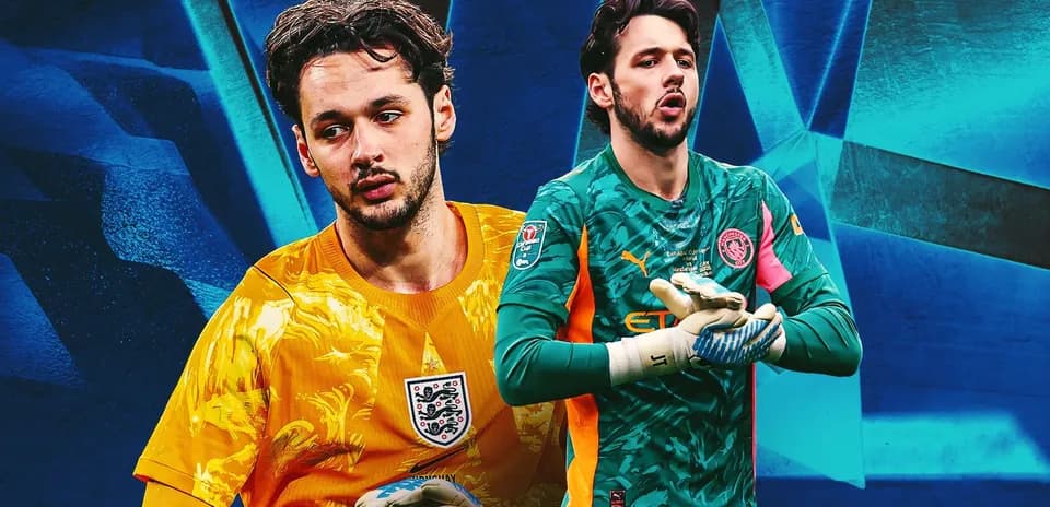 Two goalkeepers in different kits posing for photo