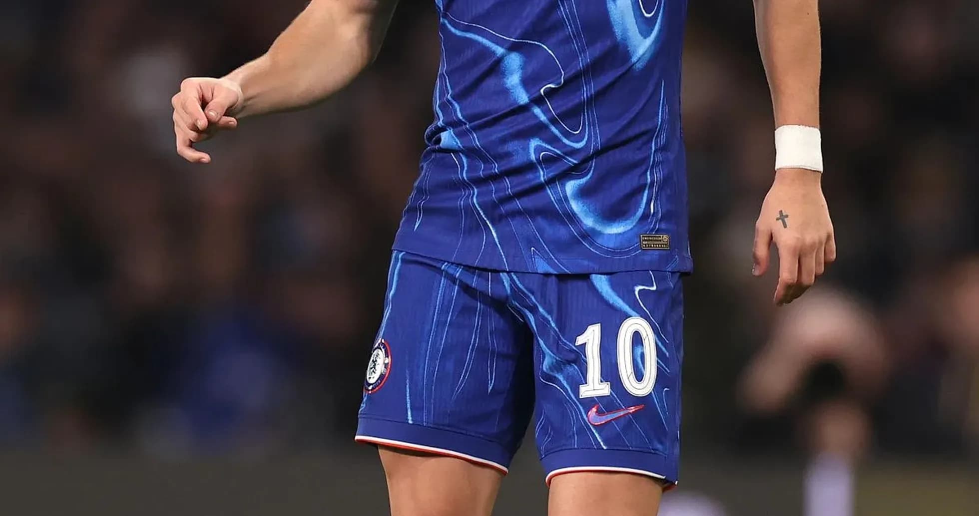 Player in blue Chelsea kit with ball on pitch