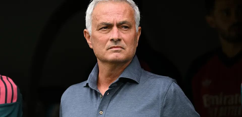 Coach observing from the sidelines during match