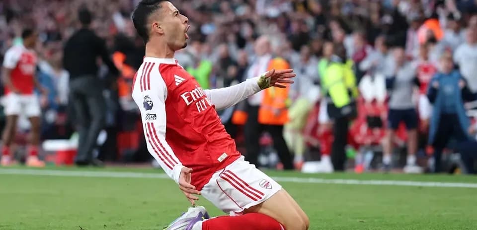 Player celebrating after scoring a goal on pitch