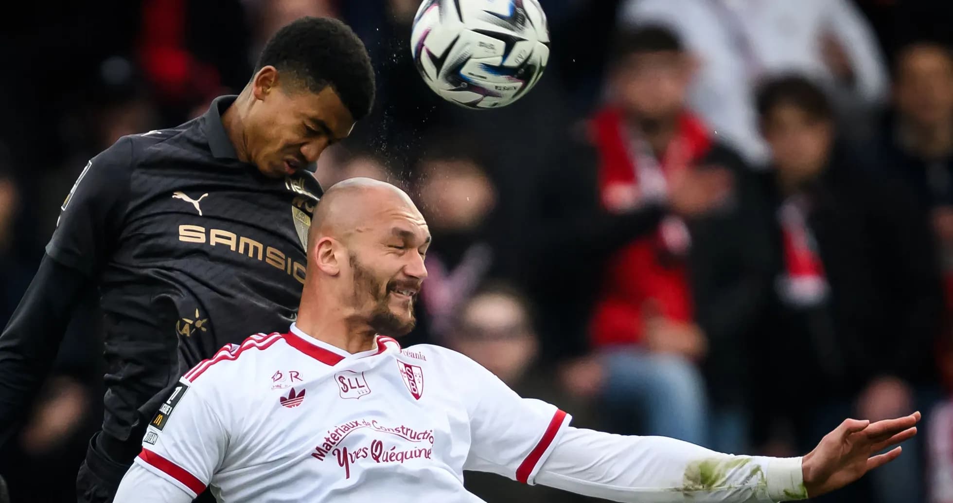 Two players contesting a header during a match