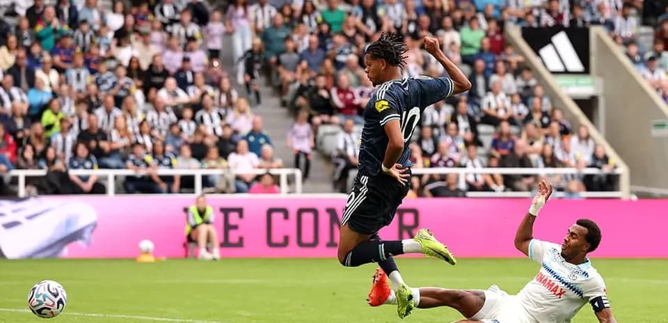Player jumping over opponent during a football match