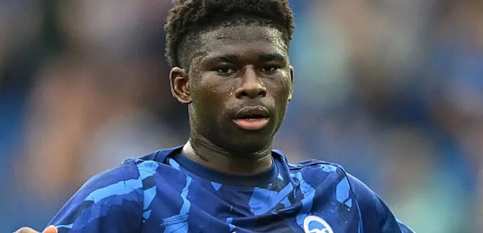 Player in blue kit during football match action