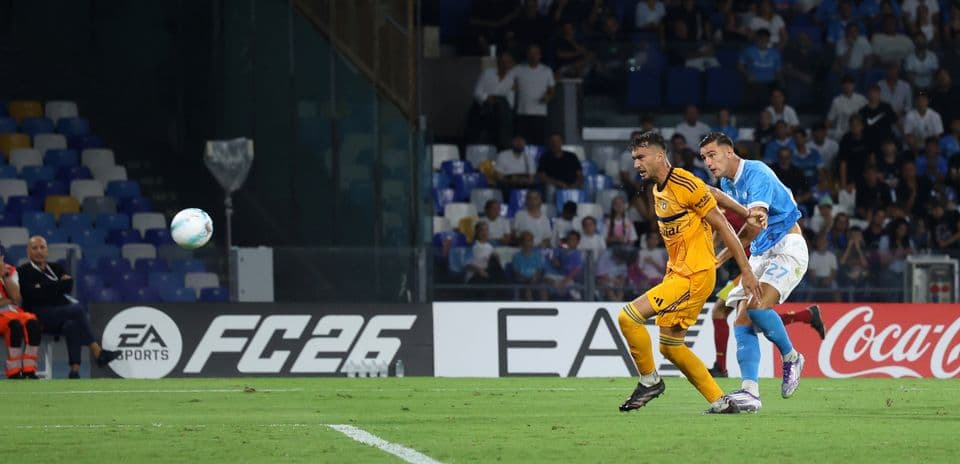 Pisa player challenged by Napoli during match
